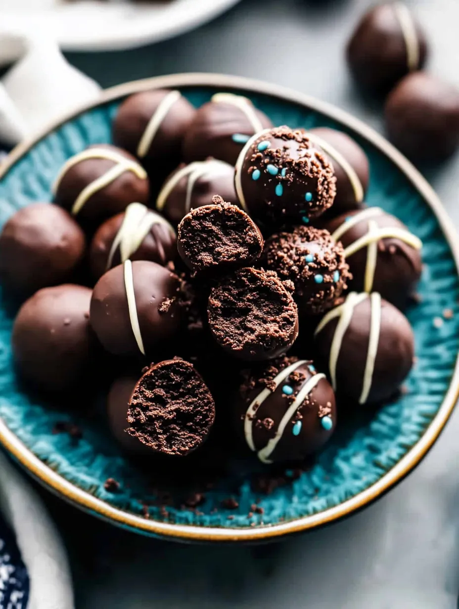 A bowl of chocolate balls with white cream.