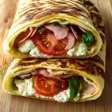 A cottage cheese flatbread sandwich with tomatoes and ham.