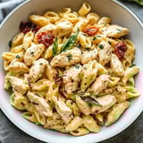 A bowl of chicken and pasta.