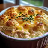 A casserole with biscuits and chicken.