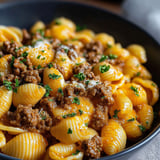 A bowl of creamy beef and shells.