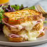 A croque monsieur sandwich with cheese and ham.