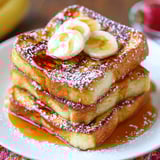 French toast with bananas and powdered sugar.