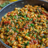A bowl of beans with green onions.