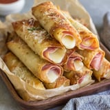A plate of baked ham and cheese mozzarella sticks.