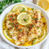 A bowl of baked lemon butter cod.