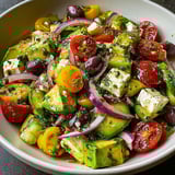 A bowl of zesty Mediterranean avocado salad.