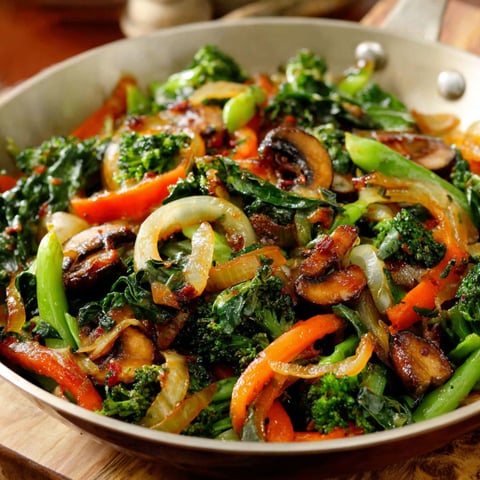 A pan of sautéed vegetables, including broccoli and carrots, on a wooden cutting board.