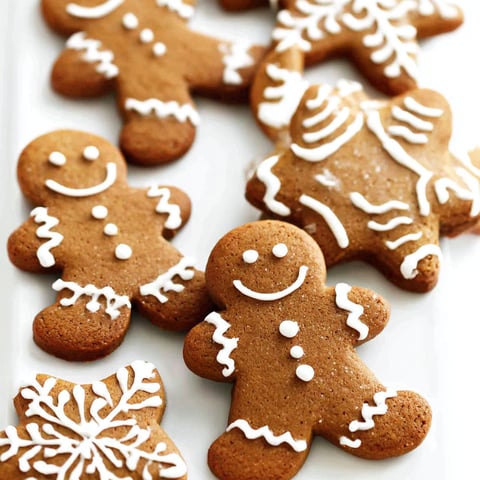 Gingerbread cookies with white icing and smiley faces.